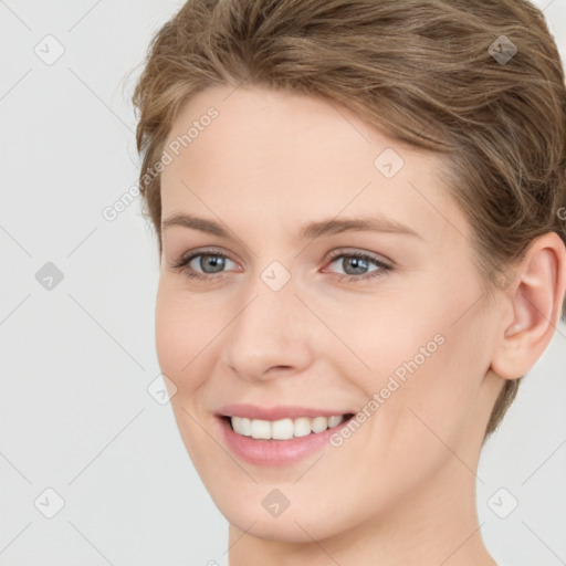 Joyful white young-adult female with short  brown hair and grey eyes