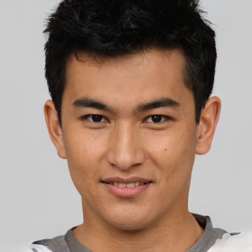 Joyful asian young-adult male with short  brown hair and brown eyes