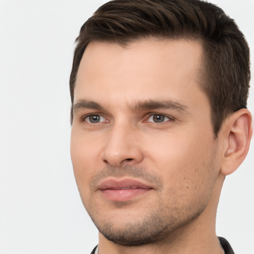 Joyful white young-adult male with short  brown hair and brown eyes