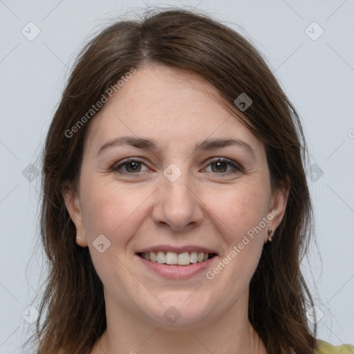 Joyful white adult female with long  brown hair and grey eyes