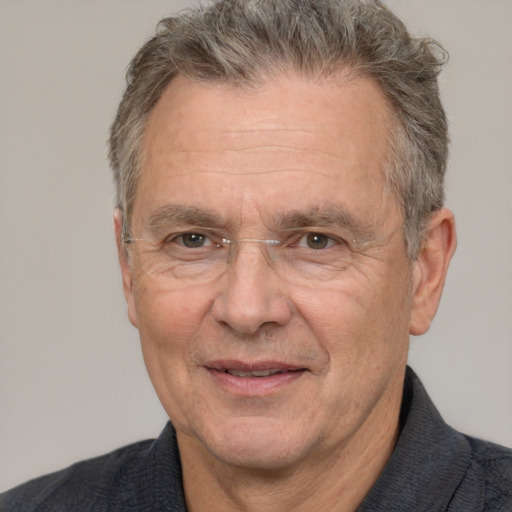 Joyful white middle-aged male with short  gray hair and brown eyes