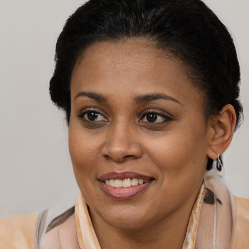 Joyful latino young-adult female with short  brown hair and brown eyes