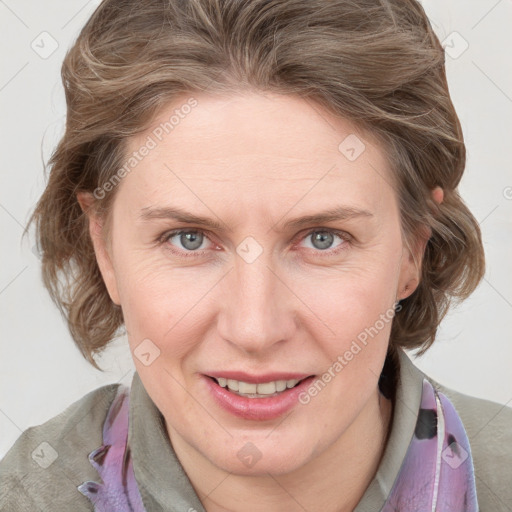 Joyful white adult female with medium  brown hair and blue eyes