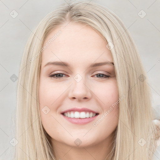 Joyful white young-adult female with long  brown hair and blue eyes