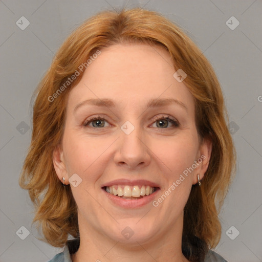 Joyful white adult female with medium  brown hair and blue eyes