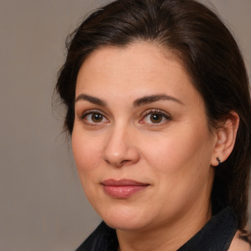 Joyful white adult female with medium  brown hair and brown eyes