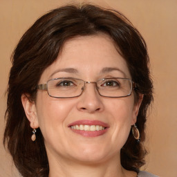 Joyful white adult female with medium  brown hair and brown eyes