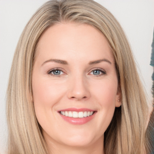 Joyful white young-adult female with long  brown hair and blue eyes