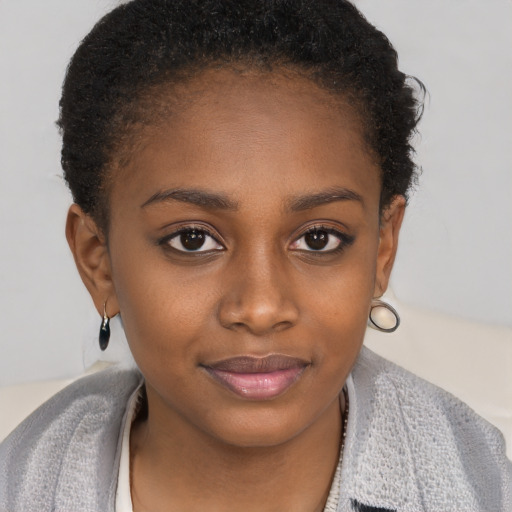 Joyful black young-adult female with short  brown hair and brown eyes