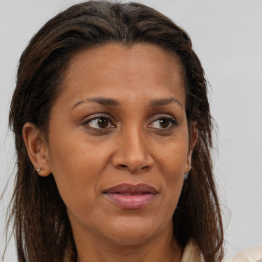 Joyful white adult female with medium  brown hair and brown eyes