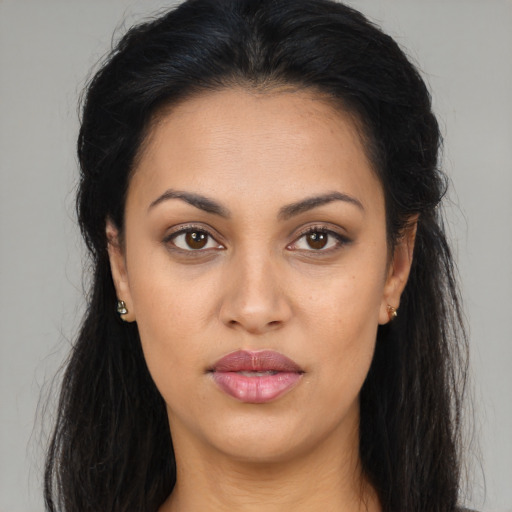 Joyful latino young-adult female with long  brown hair and brown eyes