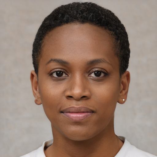 Joyful black young-adult female with short  brown hair and brown eyes