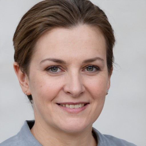 Joyful white adult female with short  brown hair and grey eyes