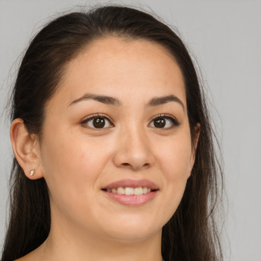 Joyful white young-adult female with long  brown hair and brown eyes