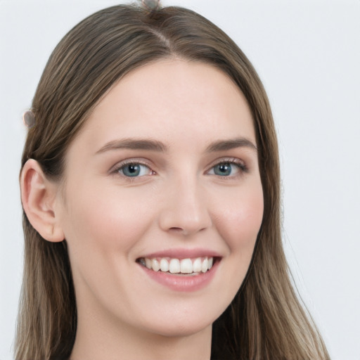 Joyful white young-adult female with long  brown hair and grey eyes