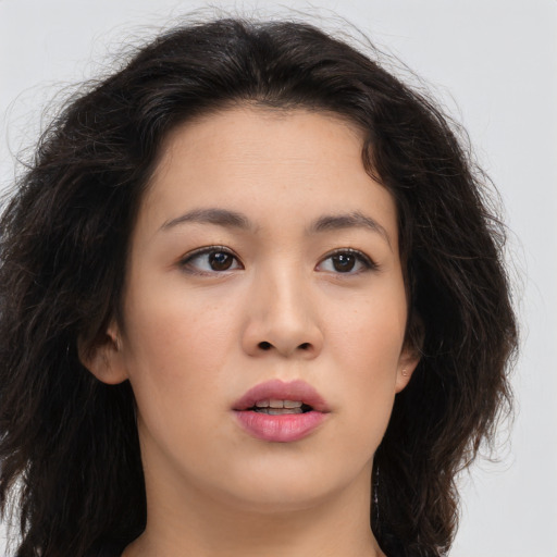 Joyful asian young-adult female with long  brown hair and brown eyes