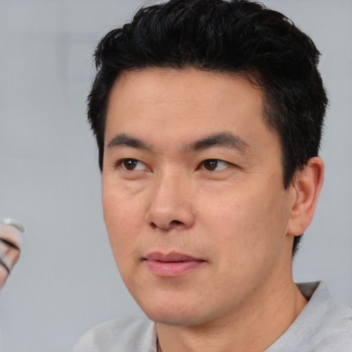 Neutral asian young-adult male with short  black hair and brown eyes