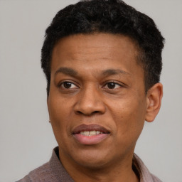 Joyful latino adult male with short  brown hair and brown eyes