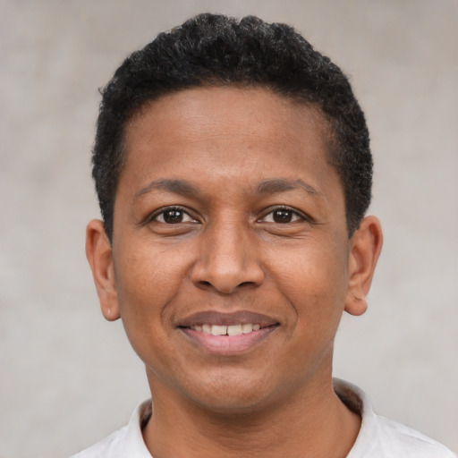 Joyful latino adult male with short  black hair and brown eyes