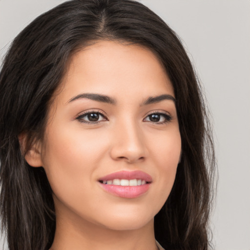 Joyful white young-adult female with long  brown hair and brown eyes