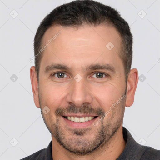 Joyful white adult male with short  brown hair and brown eyes