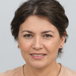 Joyful white adult female with medium  brown hair and brown eyes