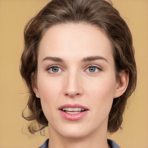 Joyful white young-adult female with medium  brown hair and green eyes