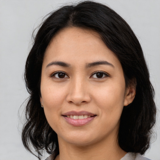 Joyful asian young-adult female with medium  brown hair and brown eyes