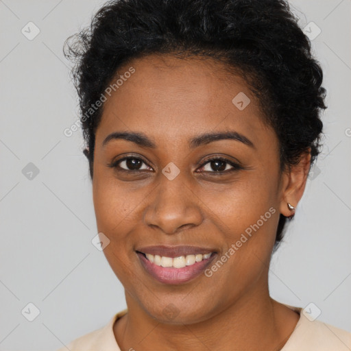 Joyful black young-adult female with short  brown hair and brown eyes