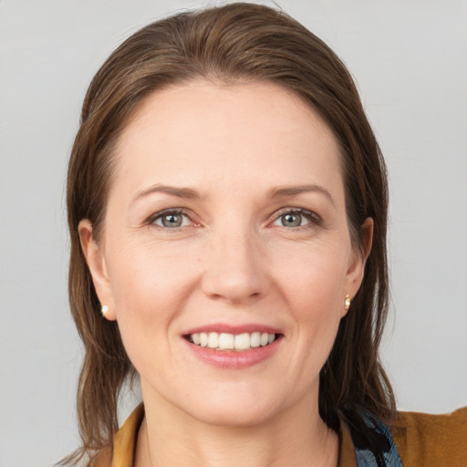 Joyful white young-adult female with medium  brown hair and blue eyes