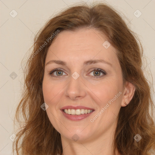 Joyful white adult female with long  brown hair and brown eyes