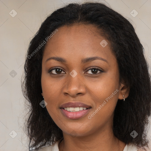 Joyful black young-adult female with long  brown hair and brown eyes