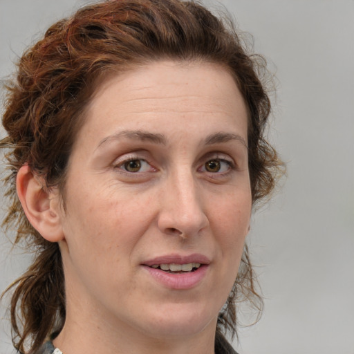 Joyful white adult female with medium  brown hair and grey eyes