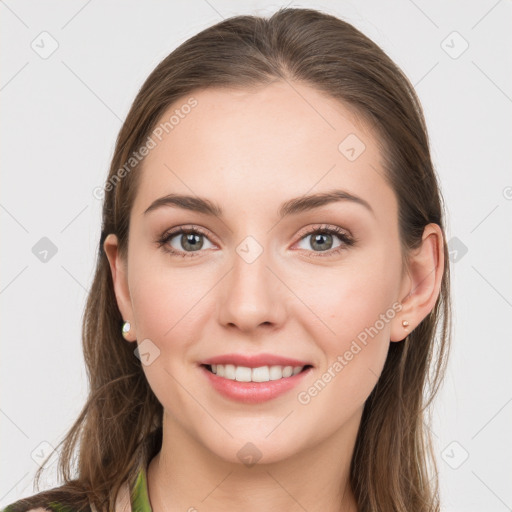 Joyful white young-adult female with long  brown hair and grey eyes