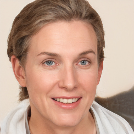 Joyful white adult female with medium  brown hair and grey eyes