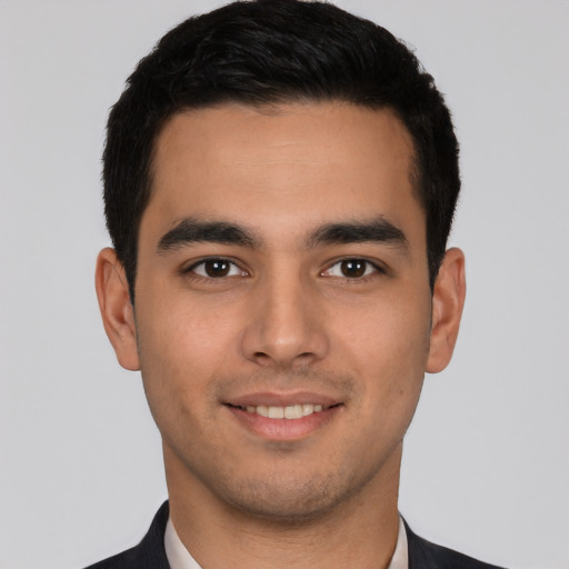 Joyful white young-adult male with short  black hair and brown eyes