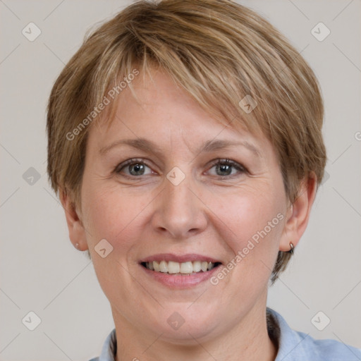 Joyful white adult female with short  brown hair and grey eyes