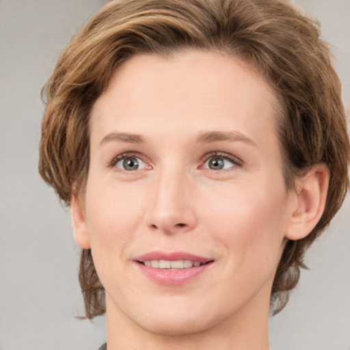 Joyful white young-adult female with medium  brown hair and green eyes