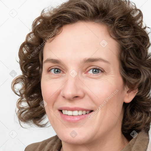 Joyful white adult female with medium  brown hair and blue eyes