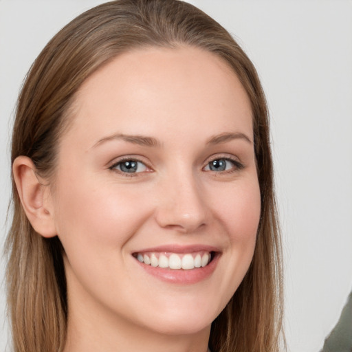 Joyful white young-adult female with long  brown hair and grey eyes