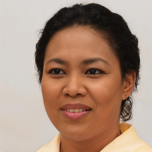 Joyful black adult female with short  brown hair and brown eyes