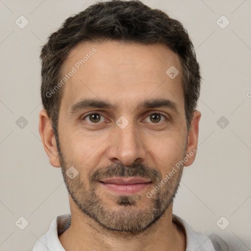 Joyful white adult male with short  black hair and brown eyes