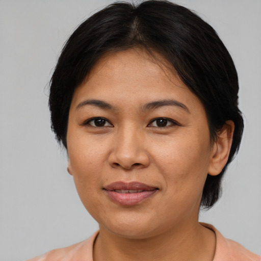 Joyful asian adult female with medium  brown hair and brown eyes