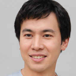 Joyful asian young-adult male with short  brown hair and brown eyes