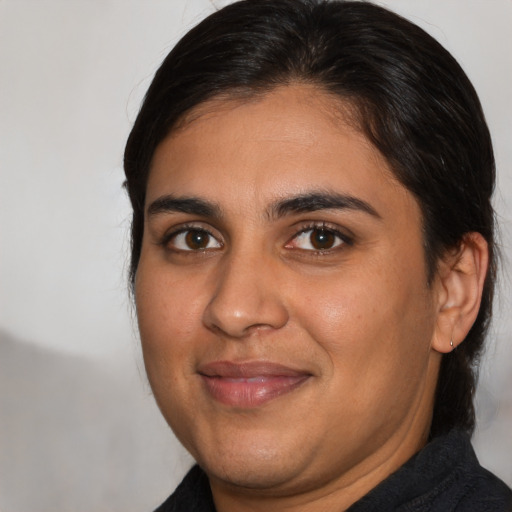 Joyful latino young-adult male with medium  brown hair and brown eyes