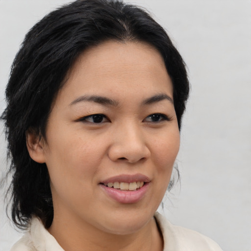 Joyful asian young-adult female with medium  brown hair and brown eyes