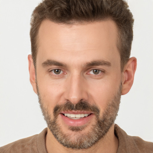 Joyful white young-adult male with short  brown hair and brown eyes