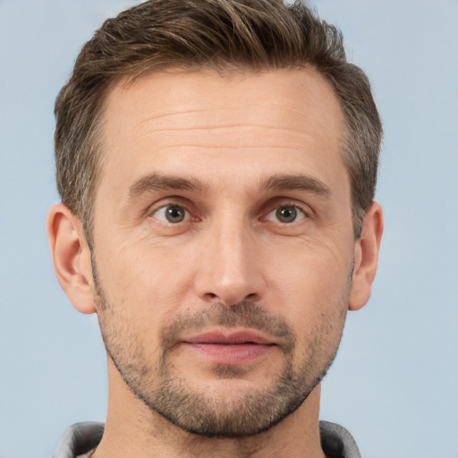 Joyful white adult male with short  brown hair and brown eyes