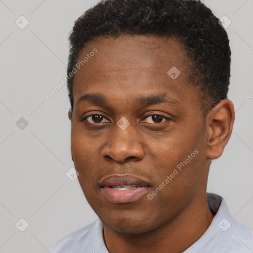 Joyful black young-adult male with short  black hair and brown eyes