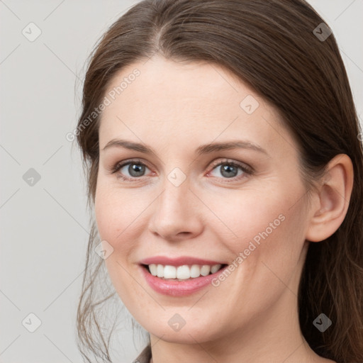 Joyful white young-adult female with long  brown hair and grey eyes